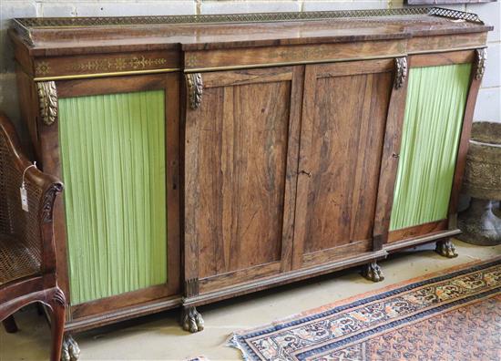 A Regency brass inset rosewood breakfront dwarf bookcase, with pierced brass three quarter gallery, two panelled and two pleated doors,